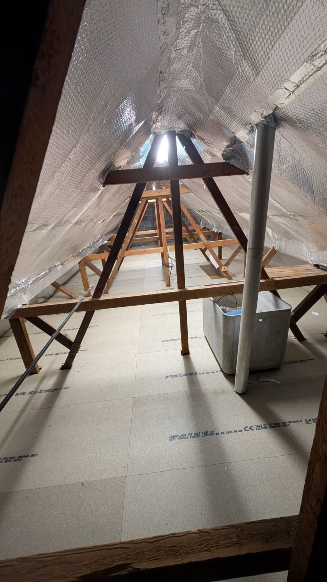 Foil loft lining around water tank with boarded floor, Henley-in-Arden install